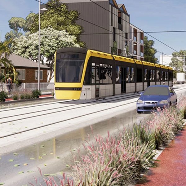An artist's impression of a Modern Tram at street level, travelling along a suburban street with a cyclist and a car on either side. Image: Auckland Light Rail